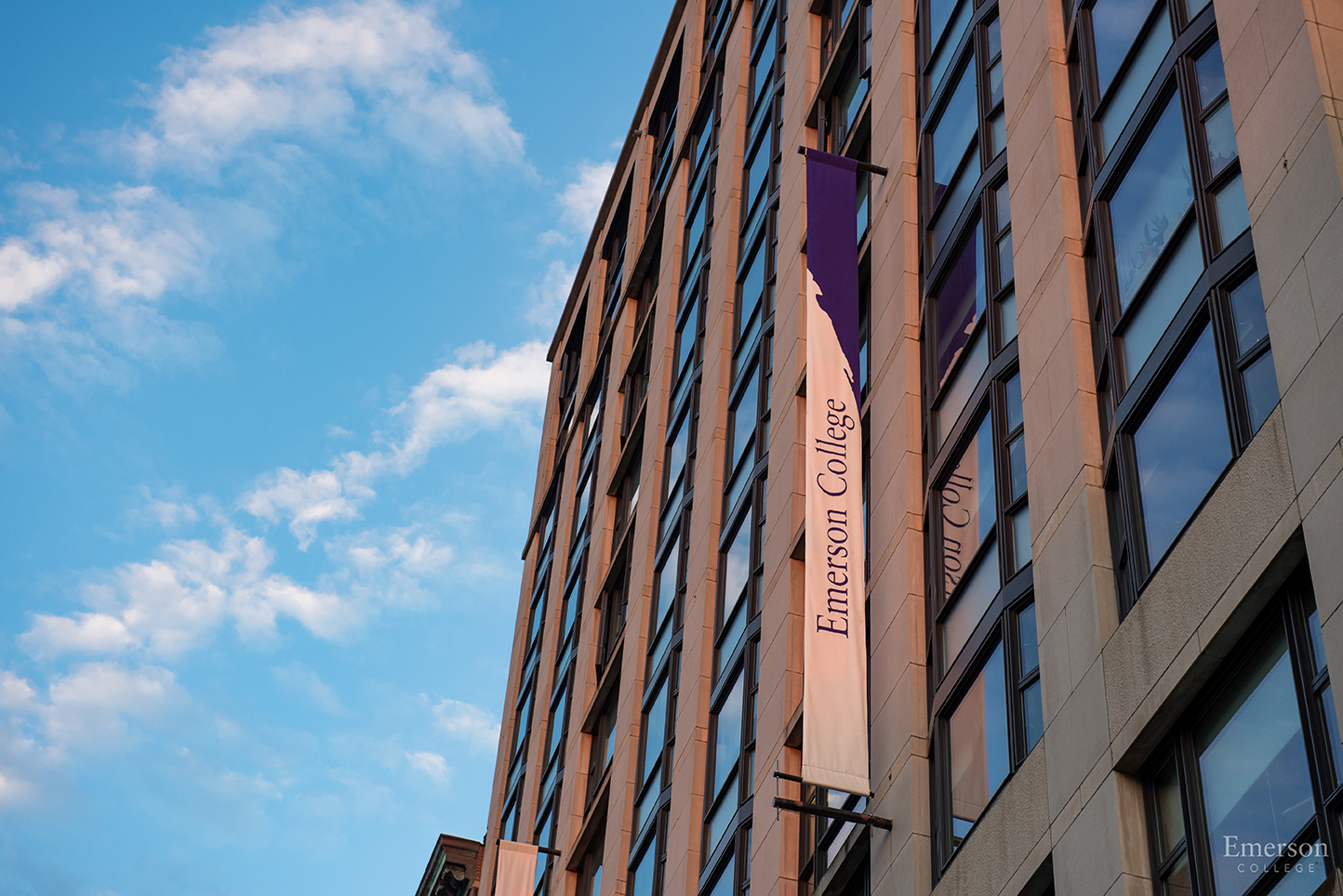 Emerson College purple and white banners against the blue